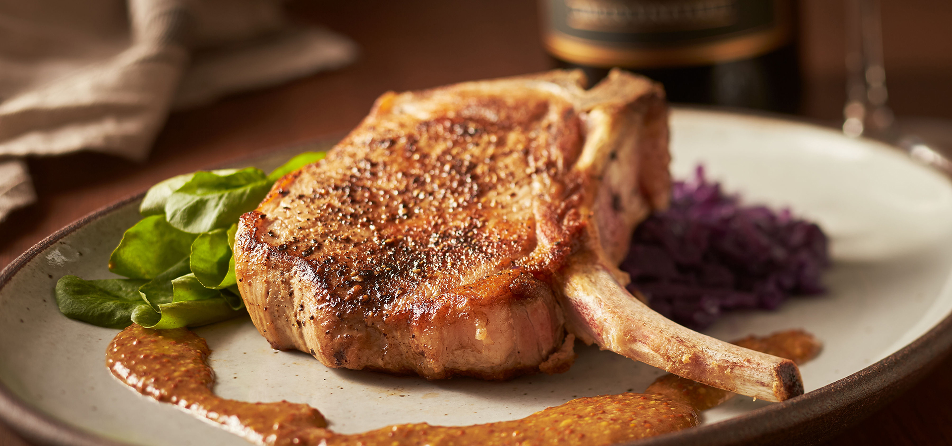 Oven-Roasted Pork Loin Chop and Cider Braised Cabbage with Whole Grain Mustard Pan-Sauce