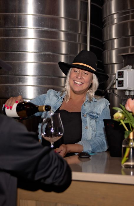 Karina Gordon, Estate Manager, pouring at an event. 