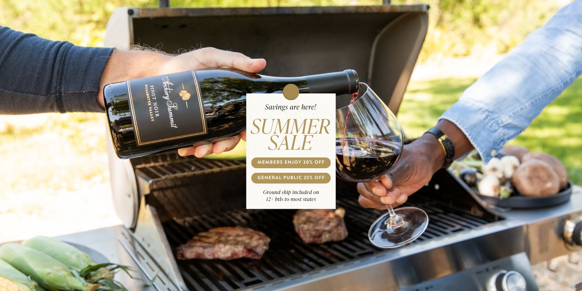 Two people pour red wine into a glass next to a barbecue grill with steaks and vegetables cooking. A sign hanging on the grill advertises a summer sale with discounts for members and the general public.